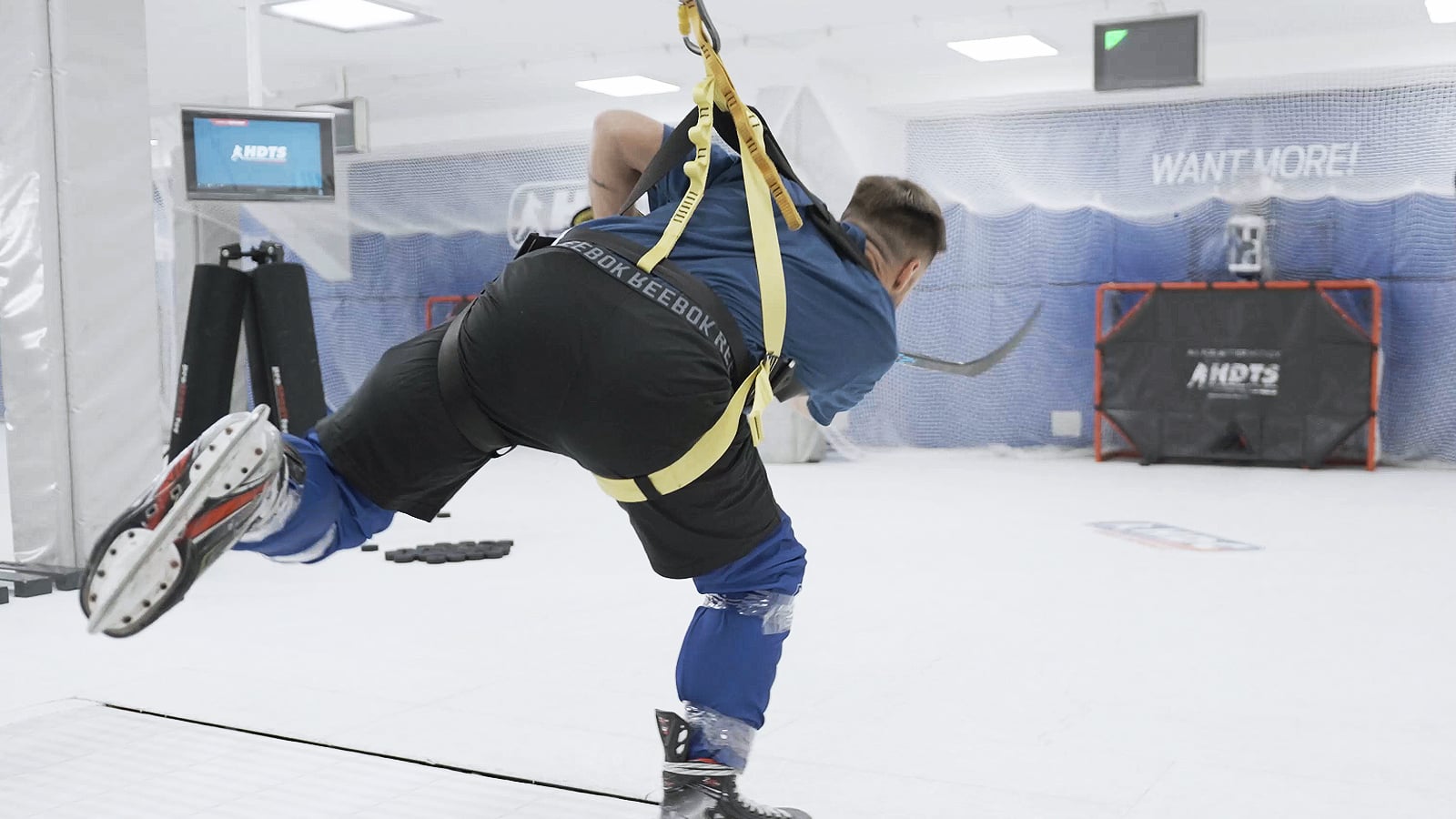 Coach applying the Fusion Skating training methodology on the HST hockey skating treadmill